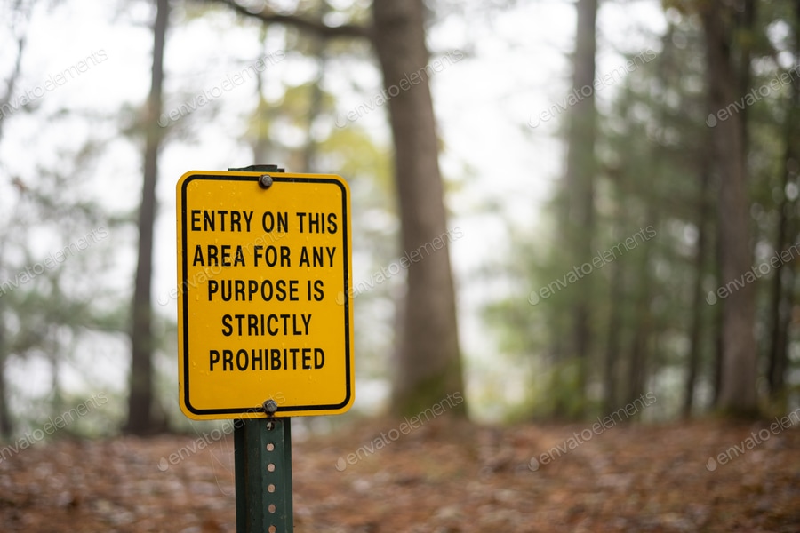 Cover for Yellow warning sign along steep cliff in Wisconsin state park