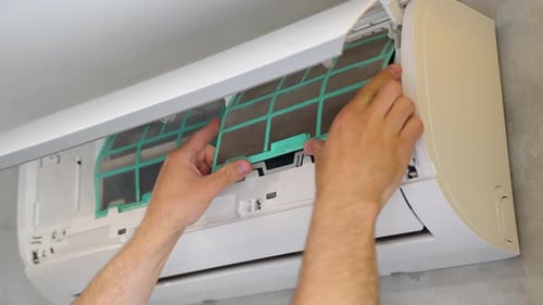 The Master Cleaning the Home Air Conditioner Close Up