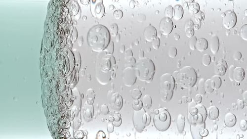 Clear Bubbles Floating in Clear Liquid Close Up
