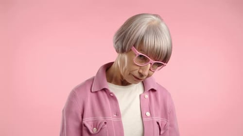 Senior Woman with Pink Glasses Looking Downward