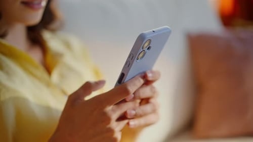 Woman Using Smartphone with Protective Case in Home