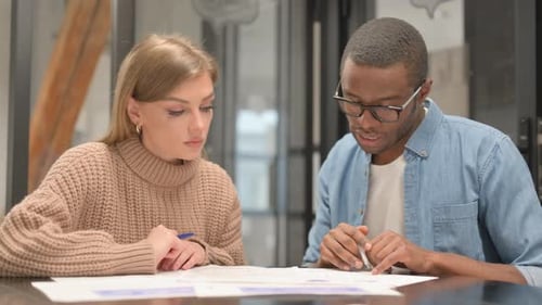 Paperwork by Multi Ethnic People in Office