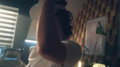 Young Adult Using Virtual Reality Headset at Home