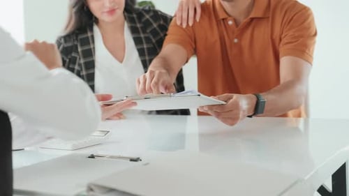 Couple Signs Documents at Office Meeting