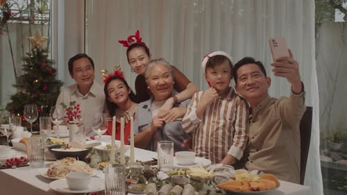 Happy Family Takes Festive Selfie at Holiday Table