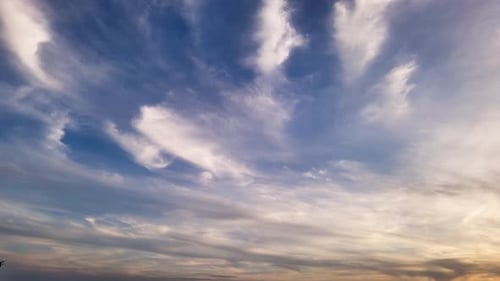 Wispy Clouds Moving Across the Serene Sky