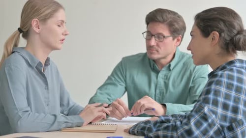 Engaged Colleagues Discussing Business in a Bright Office