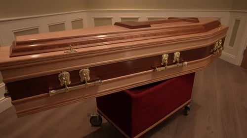 Beautiful Wooden Casket with Cross on Red Pedestal