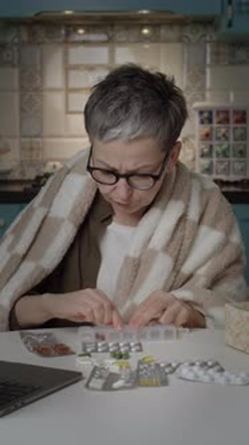 Woman with Flu Organizing Pills at Home