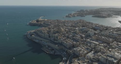 Aerial view of historic Valletta cityscape and coastal harbor, Malta.