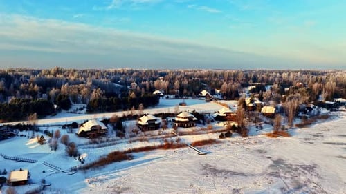 Panoramic drone view of snow-covered village in winter