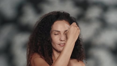 Woman Removes Wet Mask and Touches Face