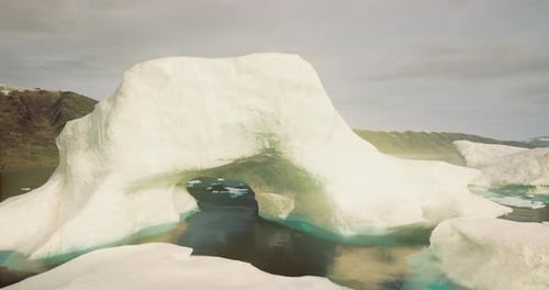 Cinematic Arctic Iceberg Archway Flyover in Icy Landscape