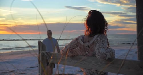 Man Walks to Woman on Beach at Sunset, Interracial Diverse Romantic Barefoot