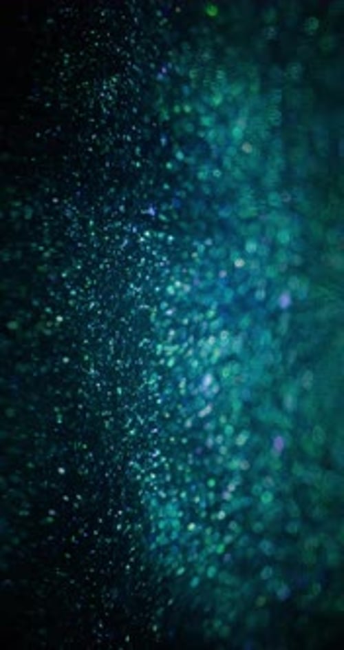 Abstract Teal Sparkles on Black Background