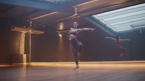 Woman Performing Ballet Moves in Dance Studio