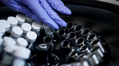 Placing Vials into Centrifuge for Science Experiment