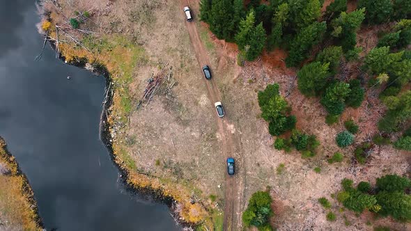 Birds Eye View Range Rover SUVs Driving Beside a Lake and a Forest ...