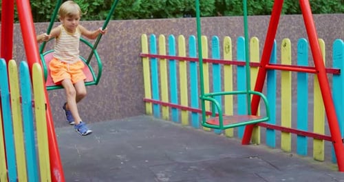 Child on Swing at Colorful Playground