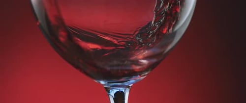 Red Wine Pouring into Glass in Close Up