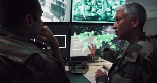 Military Personnel Reviewing Data on Computer Monitors