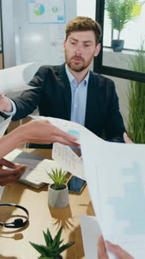 Business Meeting with Charts and Graphs at Table