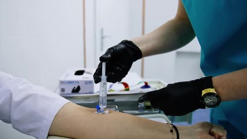 Healthcare Professional Administers Injection in Hospital Room