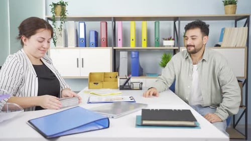 Business Deal Handshake and Payment in Office