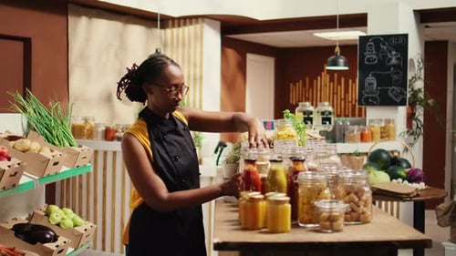Woman Arranging Jars in Grocery Store