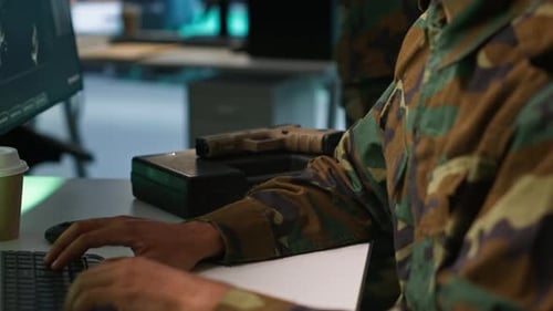 Men in Camouflage Working at Computers in Command Center