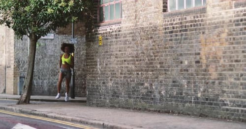 Young adult female running in urban city
