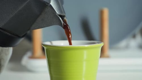 Fresh Coffee Being Poured into Bright Green Cup