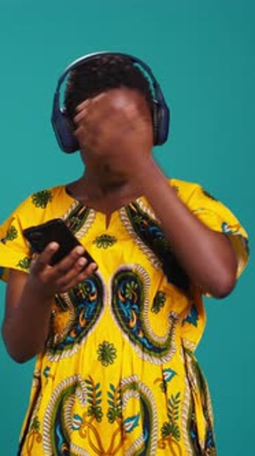 Woman Listening to Music with Headphones and Phone