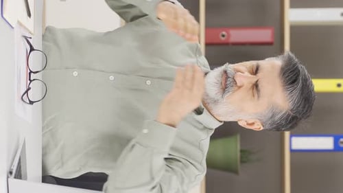 Vertical video of Office manager with headache.