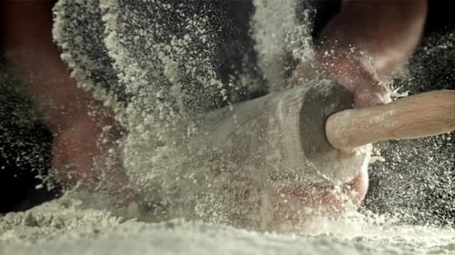 Hands Hit Rolling Pin in Flour Cloud