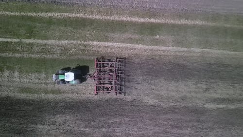 Tractor working on the field doing tillage with cultivator
