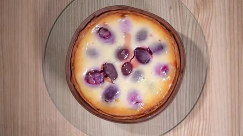 Closeup Top View Baked Blueberry Cheesecake Spinning in Slow Motion on Round Tray on Tabletop