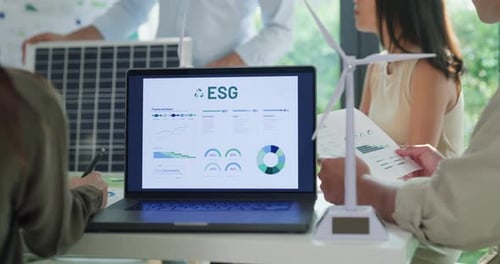 Closeup group diverse Asia businesspeople talk ESG strategies risk management workshop at office.