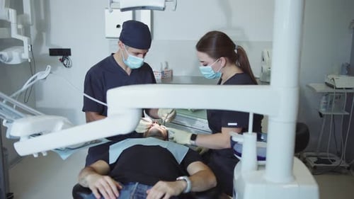 Dentist Examining Patient's Teeth in Modern Office