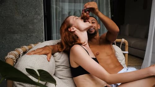 Mixedrace Couple Enjoy Their Villa with Pool Concept of Buying House