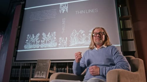 Author Sitting in Chair Promoting His New Book
