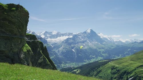 Mountain Landscape with Paragliders on a Sunny Day