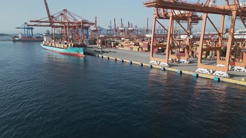 Aerial View of a Port Container Terminal with Cranes Loading a Ship