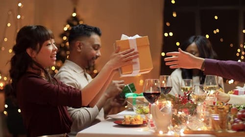 Friends Exchange Gifts at Festive Dinner Party