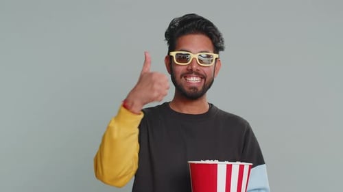 Man Wearing 3D Glasses Eating Popcorn