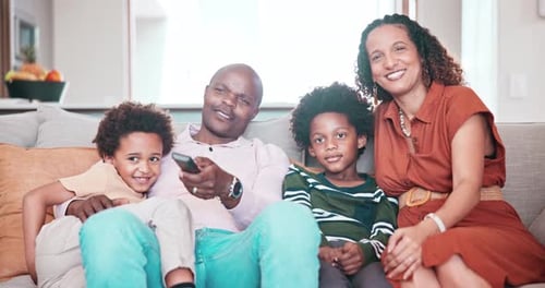 Happy Family Relaxing on Couch Together at Home