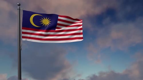Malaysian Flag Waving on Flagpole Against Cloudy Sky