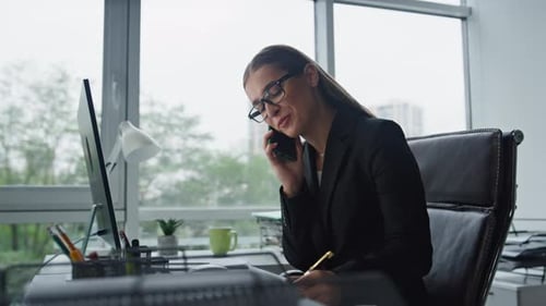 Smiling sales agent talking phone consulting client in modern office workplace