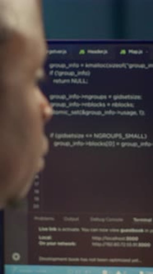 Man Analyzing Computer Code in Modern Workplace Setting