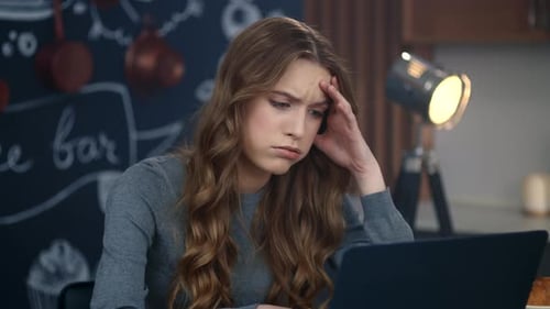 Upset Businesswoman Reading Bad Message on Laptop Computer at Home Office. Sad